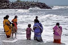 Women wading into the sea in their sari, on the beach of Mahabalipuram.