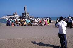 Indian visitors are having their picture taken with as a backdrop the Vivekananda Memorial and the Thiruvalluvar Statue.
