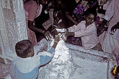 Children decorate a small statue with flour at the Meenakshi Temple in Madurai.