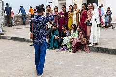Visitors posing for their picture in front of the Baradari (Darbar Hall) at the top of the citadel of Golconda Fort.