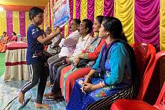 A boy administers the “tika” or “tilak” on the forehead of devotees (the ajna chakra or third eye, symbolising spirituality), at a Hindu “puja”, a ceremony in a temporary temple, Agartala.