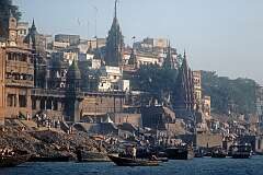 View to the “burning ghats” where people are cremated on the banks of the Ganges (Ganga) river in Varanasi.