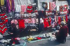Tibetan women knitting and woollen sweaters for sale, in Darjeeling.