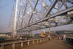 Traffic on the Howrah Bridge, a balanced cantilever bridge over the Hooghly River, Kolkata. Commissioned in 1943 it was renamed Rabindra Setu after the great Bengali poet Rabindranath Tagore, in 1965.