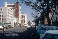 The intersection of Main Street and Eight Street in Bulawayo, the largest city in Matabeleland, with its statue of Cecil Rhodes (1853 –1902), whose British South Africa Company founded the territory of Rhodesia (now Zimbabwe and Zambia), named after him in 1895. The statue has now been replaced by one of Dr Joshua Mqabuko Nkomo, (1917 – 1999) who served as Vice-President of Zimbabwe under Robert Mugabe, from 1987 to 1999.